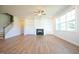 Light-filled living room offers hardwood floors, a fireplace, and built-in shelving, perfect for relaxation and entertaining at 76 Abingdon Farms Dr, Selma, NC 27576