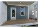 A view of a small, back porch attached to the house, including a door and a window at 1660 Piney Falls Dr, Wendell, NC 27591