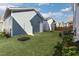 An expansive backyard featuring newly installed sod and a side entrance to the house at 1660 Piney Falls Dr, Wendell, NC 27591