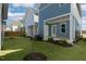 A spacious backyard showcases a manicured lawn and multiple houses in the community at 1660 Piney Falls Dr, Wendell, NC 27591