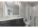 Modern bathroom with double vanity, sleek fixtures, and a glass-enclosed shower at 1660 Piney Falls Dr, Wendell, NC 27591