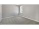 A bright bedroom with a large window and neutral carpet flooring at 1660 Piney Falls Dr, Wendell, NC 27591