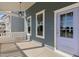 View of a charming front porch with a light-purple door and a hanging outdoor light at 1660 Piney Falls Dr, Wendell, NC 27591