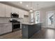 Kitchen featuring an island with pendant lights, stainless steel appliances and white cabinetry at 1660 Piney Falls Dr, Wendell, NC 27591