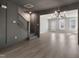 Bright living room featuring hardwood floors, a modern chandelier, and easy access to the staircase at 1660 Piney Falls Dr, Wendell, NC 27591
