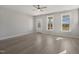 Open-concept living room with hardwood floors, a ceiling fan, and natural light, perfect for relaxation at 1660 Piney Falls Dr, Wendell, NC 27591