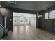 Spacious living room featuring hardwood floors, a staircase, and elegant light fixtures at 1660 Piney Falls Dr, Wendell, NC 27591
