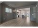 Open living area with hardwood floors, modern chandelier, and seamless transition into the kitchen at 1660 Piney Falls Dr, Wendell, NC 27591