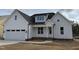 Charming white two-story home featuring an attached garage and a welcoming front porch at 2316 Eagle Shot Ct # 21, Fuquay Varina, NC 27526