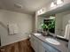 Elegant bathroom featuring double sinks, a modern vanity, and a well-lit mirror at 19 Longdale Dr, Graham, NC 27253