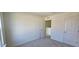 Bright bedroom featuring neutral carpet, walk in closet and an open doorway to the landing at 19 Longdale Dr, Graham, NC 27253