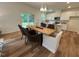 Open dining area with a herringbone-patterned table, pendant lighting, and ample seating at 19 Longdale Dr, Graham, NC 27253