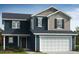 Exterior features a two-story home with a dark blue facade, white trim, shutters, and garage at 19 Longdale Dr, Graham, NC 27253