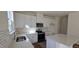 Bright kitchen features white cabinets, modern appliances, stone countertops, and hardwood style floors at 19 Longdale Dr, Graham, NC 27253