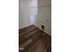 Laundry room with wood-look floors, washer/dryer hookups and a wire shelf for added storage at 19 Longdale Dr, Graham, NC 27253