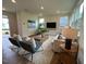 Cozy living room with stylish furniture, a patterned rug, and plenty of natural light at 19 Longdale Dr, Graham, NC 27253
