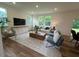 Spacious living room with a large TV, comfortable seating, and a neutral color scheme at 19 Longdale Dr, Graham, NC 27253
