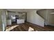Open-concept living room and kitchen boasts an island, chandelier, and wood-style flooring throughout at 19 Longdale Dr, Graham, NC 27253