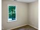 Spacious bedroom with a large window and neutral wall color at 7220 Shellburne Dr, Raleigh, NC 27612