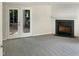 Bright living room featuring a fireplace and sliding glass doors leading to the backyard at 7220 Shellburne Dr, Raleigh, NC 27612