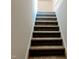 Carpeted staircase leading to the upper level at 7220 Shellburne Dr, Raleigh, NC 27612
