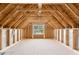 Unfinished attic showcasing wood framing and a window at 167 Thistle Ct, Sanford, NC 27332