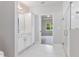 Bright bathroom featuring white cabinets and marble floors leading to an open bedroom at 167 Thistle Ct, Sanford, NC 27332