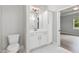 Bright bathroom with white vanity, toilet, and tiled floors at 167 Thistle Ct, Sanford, NC 27332