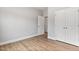 Neutral bedroom features wood-look flooring, two closets, and interior door at 167 Thistle Ct, Sanford, NC 27332
