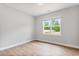Neutral bedroom with wood-look flooring and a bright window with green outdoor view at 167 Thistle Ct, Sanford, NC 27332