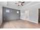 Spacious bedroom with hardwood floors, shiplap accent wall, and ceiling fan at 167 Thistle Ct, Sanford, NC 27332