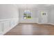 Bright dining room featuring large window, chandelier and paneled walls at 167 Thistle Ct, Sanford, NC 27332