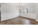Dining room with hardwood floors, paneled walls and elegant chandelier at 167 Thistle Ct, Sanford, NC 27332