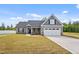 Lovely home exterior with a two-car garage, inviting front yard, and tasteful exterior accents at 167 Thistle Ct, Sanford, NC 27332