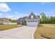 Beautiful home showcasing a spacious driveway, attached two-car garage, and manicured lawn at 167 Thistle Ct, Sanford, NC 27332