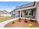 Attractive home with a manicured lawn, stylish landscaping, and a covered front porch entrance at 167 Thistle Ct, Sanford, NC 27332