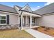 Inviting front porch with stone accents and manicured landscaping at 167 Thistle Ct, Sanford, NC 27332