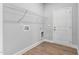 Functional laundry area with shelving, utility connections, and durable wood-look flooring at 167 Thistle Ct, Sanford, NC 27332
