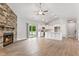 Open-concept living space with fireplace, sliding doors to the backyard, and kitchen at 167 Thistle Ct, Sanford, NC 27332