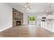 Open-concept living space with fireplace, sliding doors to the backyard, and kitchen at 167 Thistle Ct, Sanford, NC 27332