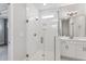 Elegant bathroom featuring frameless glass shower with white tiled walls and floor at 167 Thistle Ct, Sanford, NC 27332