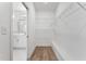 Bright walk-in closet with wire shelving and wood floor, adjacent to a bathroom with white vanity at 167 Thistle Ct, Sanford, NC 27332