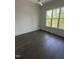 Bedroom with a large window and hardwood floors at , Pittsboro, NC 27312