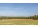 Scenic golf course showcasing well-manicured greens, trees and a beautiful landscape under a clear sky at , Pittsboro, NC 27312