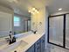 Modern bathroom with double sinks, sleek black fixtures, and a walk-in shower at 17 S Mistflower St, Clayton, NC 27520
