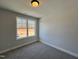 Bright, carpeted bedroom with a neutral color scheme and a large window at 17 S Mistflower St, Clayton, NC 27520