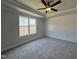 Cozy bedroom boasts carpet floors, a large window, and natural lighting at 17 S Mistflower St, Clayton, NC 27520