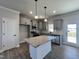 Modern kitchen featuring gray cabinetry, granite countertops, stainless steel appliances, and a center island at 17 S Mistflower St, Clayton, NC 27520