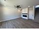 Spacious living room with modern fireplace, built-in shelving, ceiling fan, and neutral walls at 17 S Mistflower St, Clayton, NC 27520