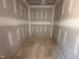 Drywalled and unfinished walk-in closet with plywood flooring and plenty of room for storage at 182 Wilderness Trl, Smithfield, NC 27577